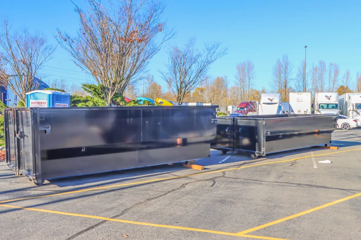 Professional dumpster rental service with roll-off container on residential driveway in Altamont